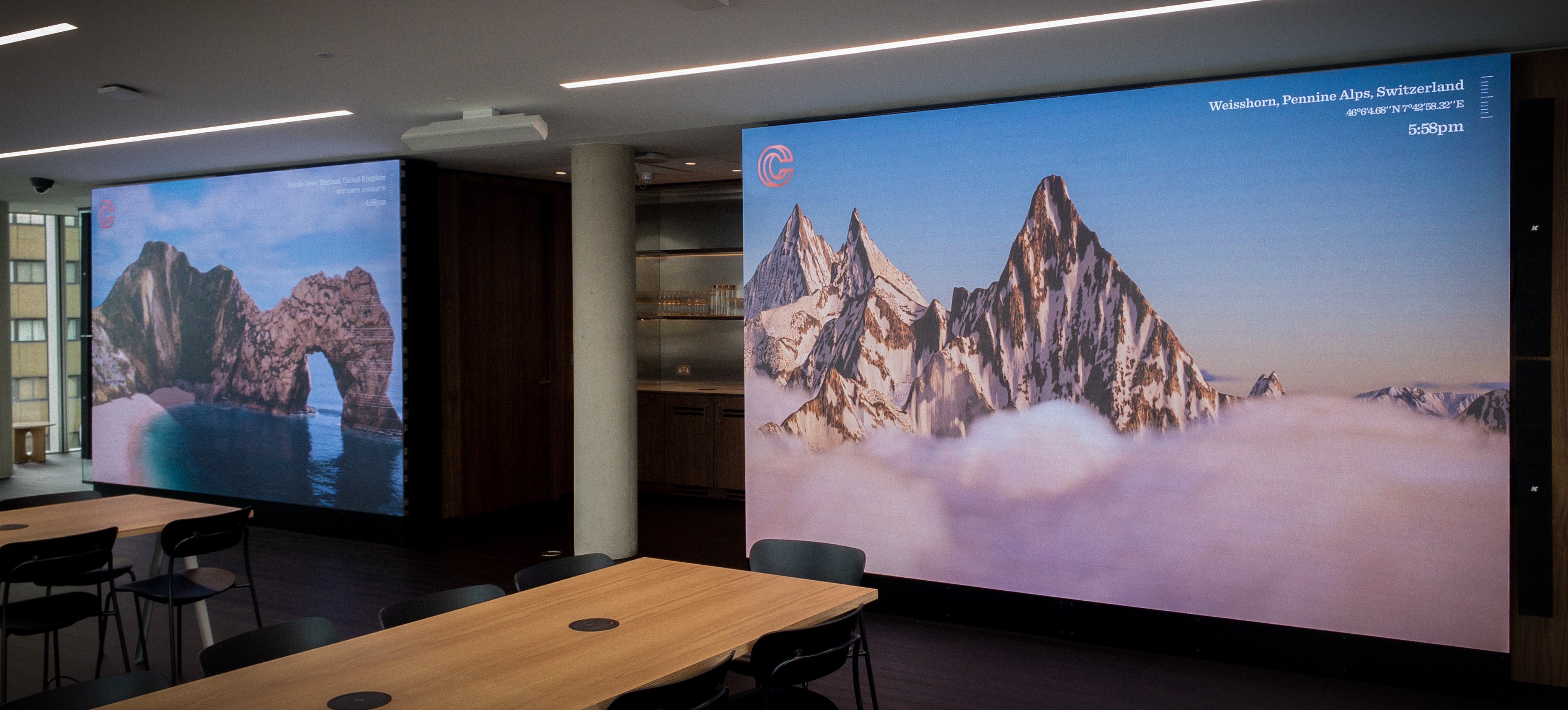 Two separate screens showing a mountainous alps scene and Durdle Door in the UK.