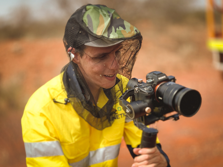 A camera operator wearing a fly net.